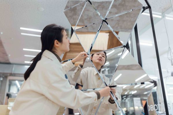 A student works with mirrors in the robotics lab