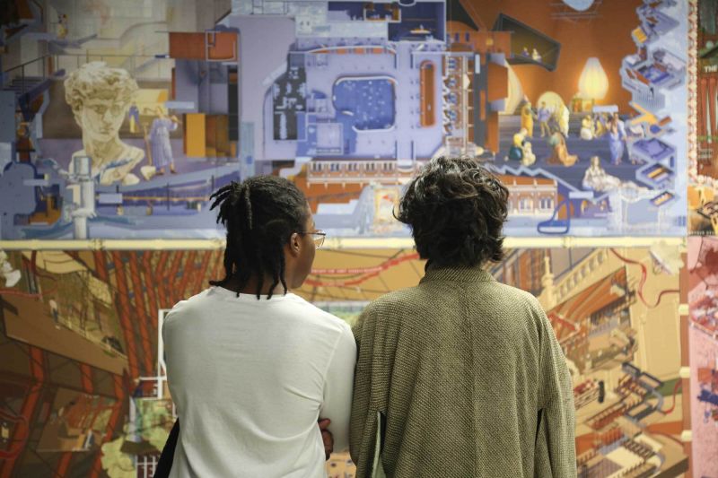 People looking at student work