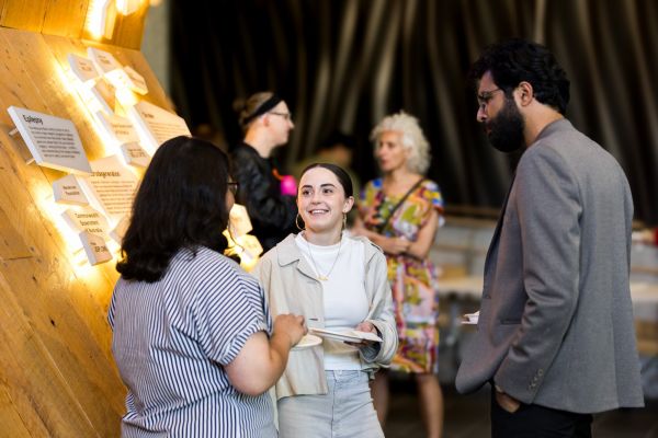 A group of people participating in a discussion during a break from a symposium.