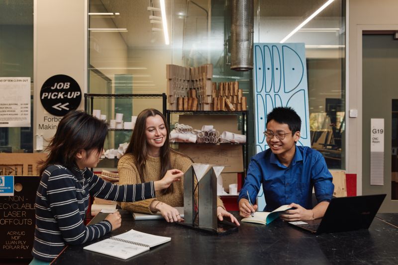 A group of students work on a model in the maker spaces.