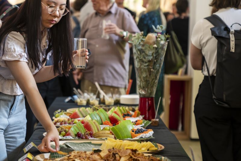 A table covered with catered food for an exhibition opening