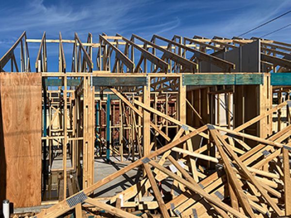 Photo of timber stud frame of building.