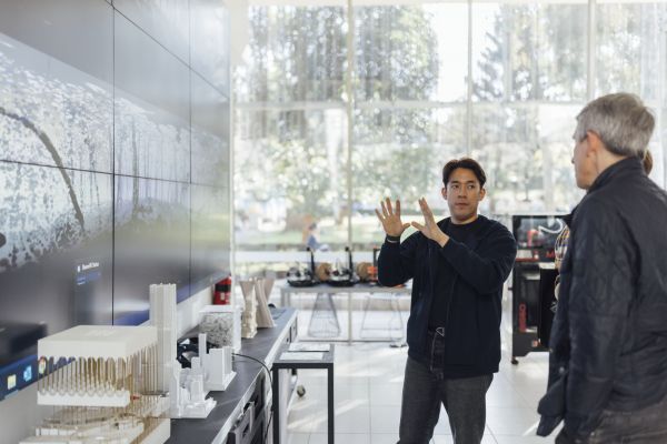A researcher displays 3D scans on a large digital display.