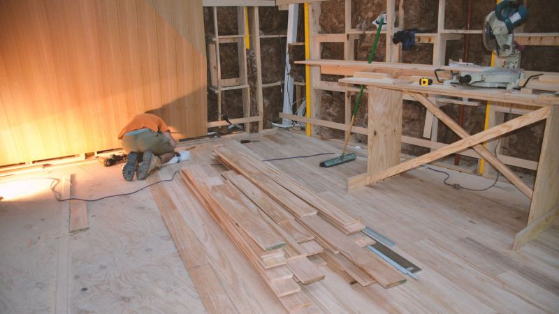 Laying the timber flooring.