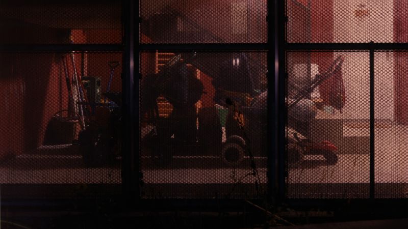 shot of prams behind mesh wall