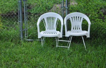 A photograph of two garden chairs which have had their legs replaced.