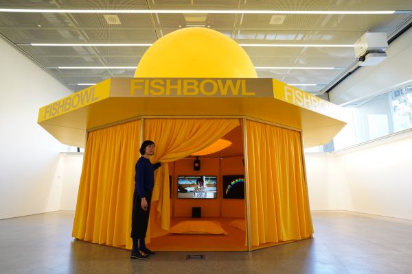A person open the curtain to enter an exhibition in the Design Gallery.