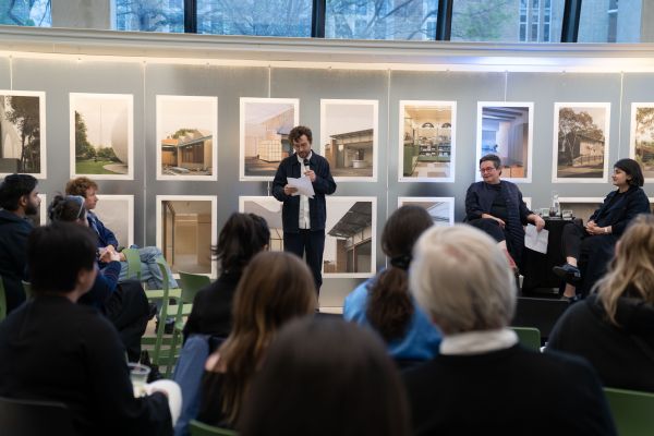 Image of guests sitting at event, listening to speech 