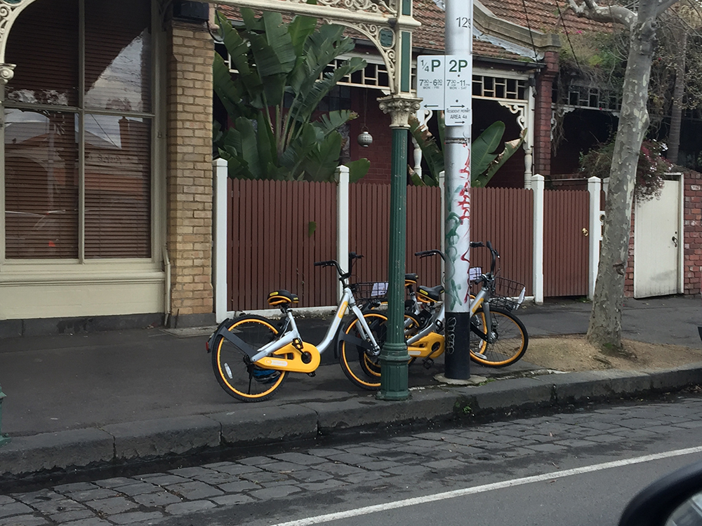 Two bikes on the street in Carlton