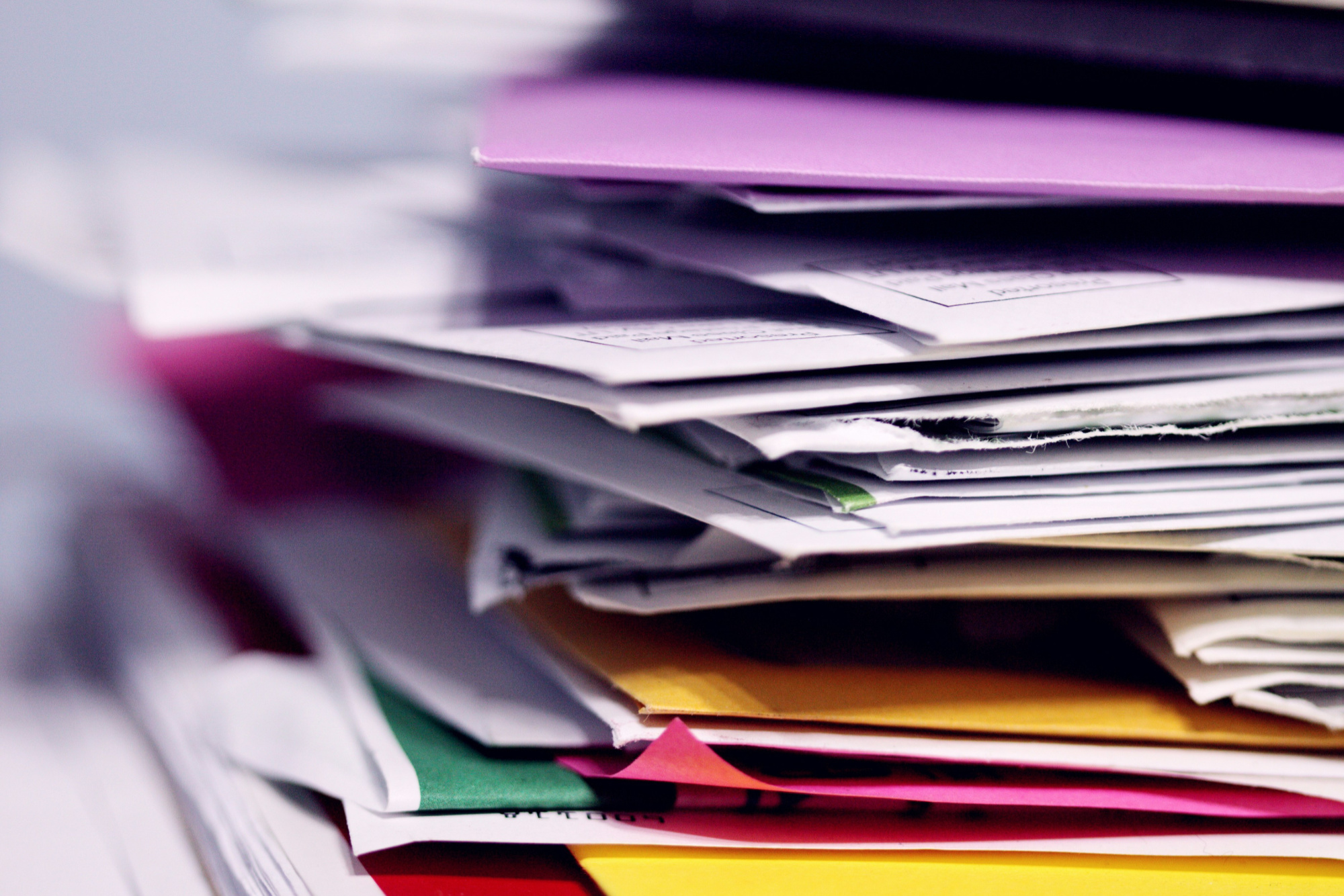 A stack of colourful papers and folders