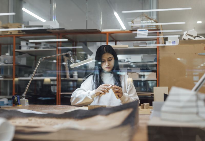 A student making an architectural model 