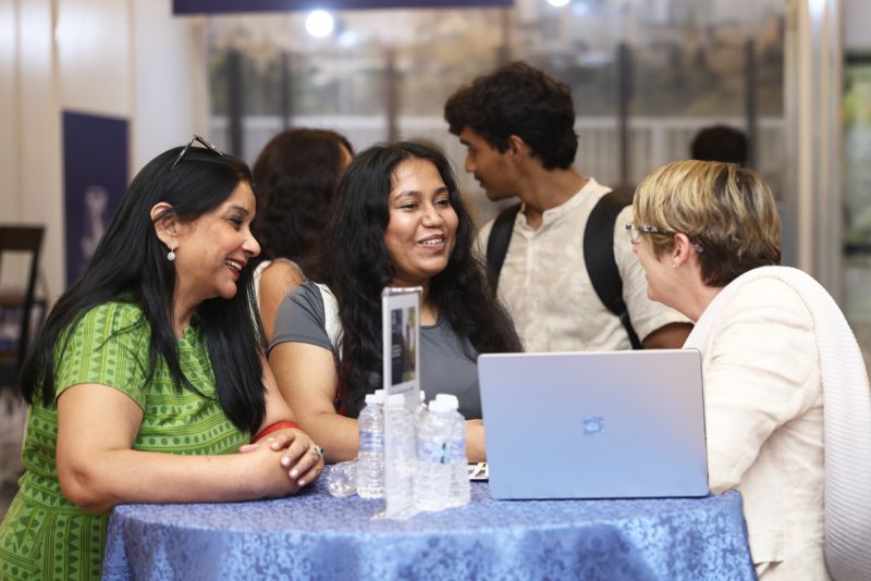 Three women talking and smiling