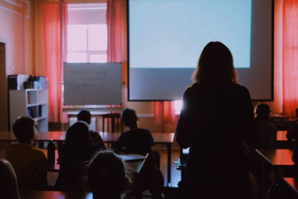 A woman stands in a lecture hall