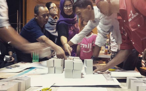People Collaborating on Building an Architecture Model
