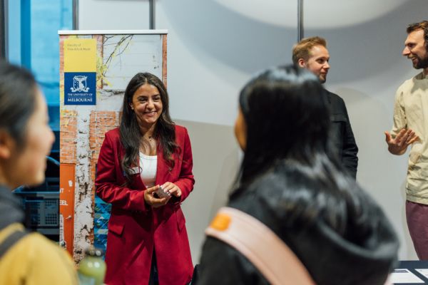 UniMelb in Brisbane A woman in a red blazer smiling