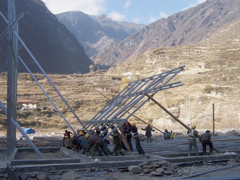 Local residents and the architect's team working together to lift a structure