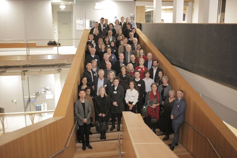 Award recipients, sponsors, guests and Melbourne School of Design staff gather on the stairs at MSD.