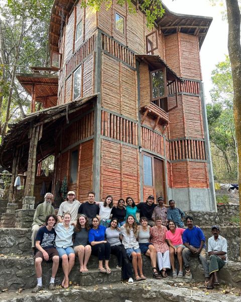 Students sitting and smiling for a picture in Kerala, India.
